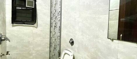 A modern bathroom with a toilet, sink, and shower.