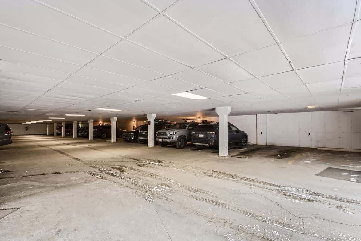 A multi-level parking garage with concrete floors and white pillars.
