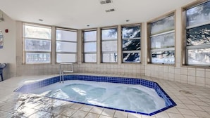 A large indoor swimming pool with a blue border, surrounded by large windows with a view of trees. - Near Lifts, Ski Keystone, Sleeps up to 6 People (Keystone)