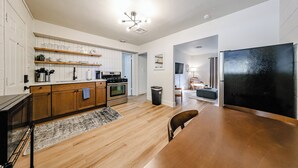 A modern kitchen with wooden cabinets, a built-in oven, and a black refrigerator.