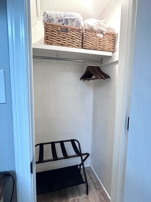 A narrow hallway with a metal bench, a hanging rack, and wicker baskets on a shelf. - Lakeview 1BR/1BA guest suite, close to Asheville, hiking, skiing, rafting, BRP. (Weaverville)