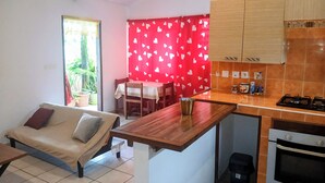 A compact living space with a kitchenette, a dining area, and a sofa. - THE MILANOSIMPLY (Kourou)