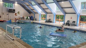 An indoor swimming pool with a high ceiling, clear poolside area, and a goal post. - Remarkable 3-bed Lodge in St Minver (Wadebridge)