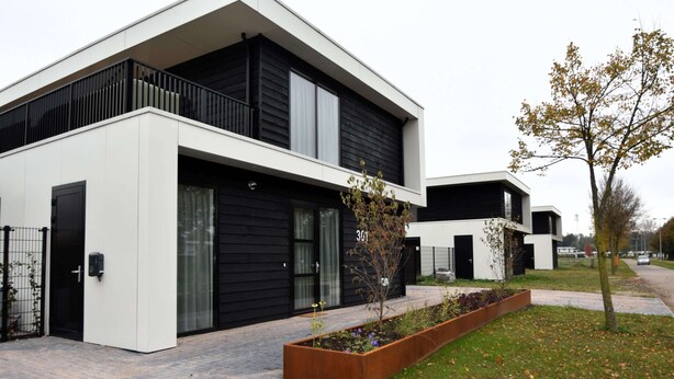 A modern two-story building with a black and white facade, large windows, and a small garden area. - Luxury 10p Villa on the Water Near Harderwijk (Zeewolde)