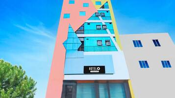 A multi-story hotel with a modern design, featuring a prominent 'HOTEL' sign on the facade.