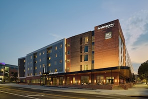 A multi-story hotel with a modern design, featuring a prominent AC Hotels Marriott sign.