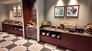 Una mesa de buffet con diferentes alimentos y un tostador.