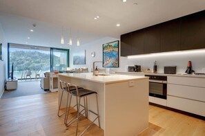 Fridge, microwave, oven, stovetop - Hobsonville 2BR Waterfront Gem with Water Views (Auckland West)