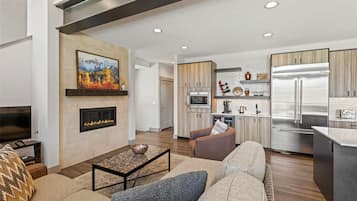 A modern living room with a fireplace, a television, and a sofa.