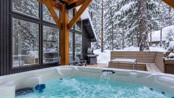 Covered hot tub beside the forest.