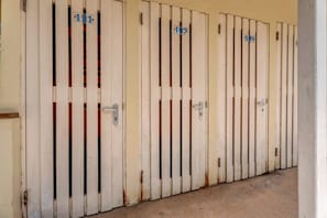 A row of closed doors with numbers 111, 107, and 109 visible. - Caribbean Club 111 Parrots Perch on a small-scale resort with beautiful views (Kralendijk)