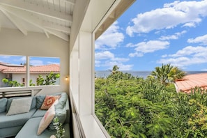 A balcony with a view of the sea and a building with red-tiled roofs. - Caribbean Club 111 Parrots Perch on a small-scale resort with beautiful views (Kralendijk)