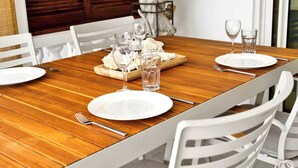A dining table set with plates, cutlery, glasses, and a wooden board with food. - Apartment Belmar 6 with a beautiful view and refreshing shared pool (Kralendijk)