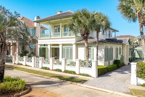 A two-story house with a balcony, a driveway, and a white fence. - Casa Del Mare Caribe (Miramar Beach)