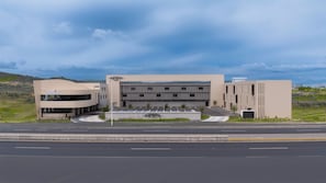 A modern hotel with a central building and a smaller annex.