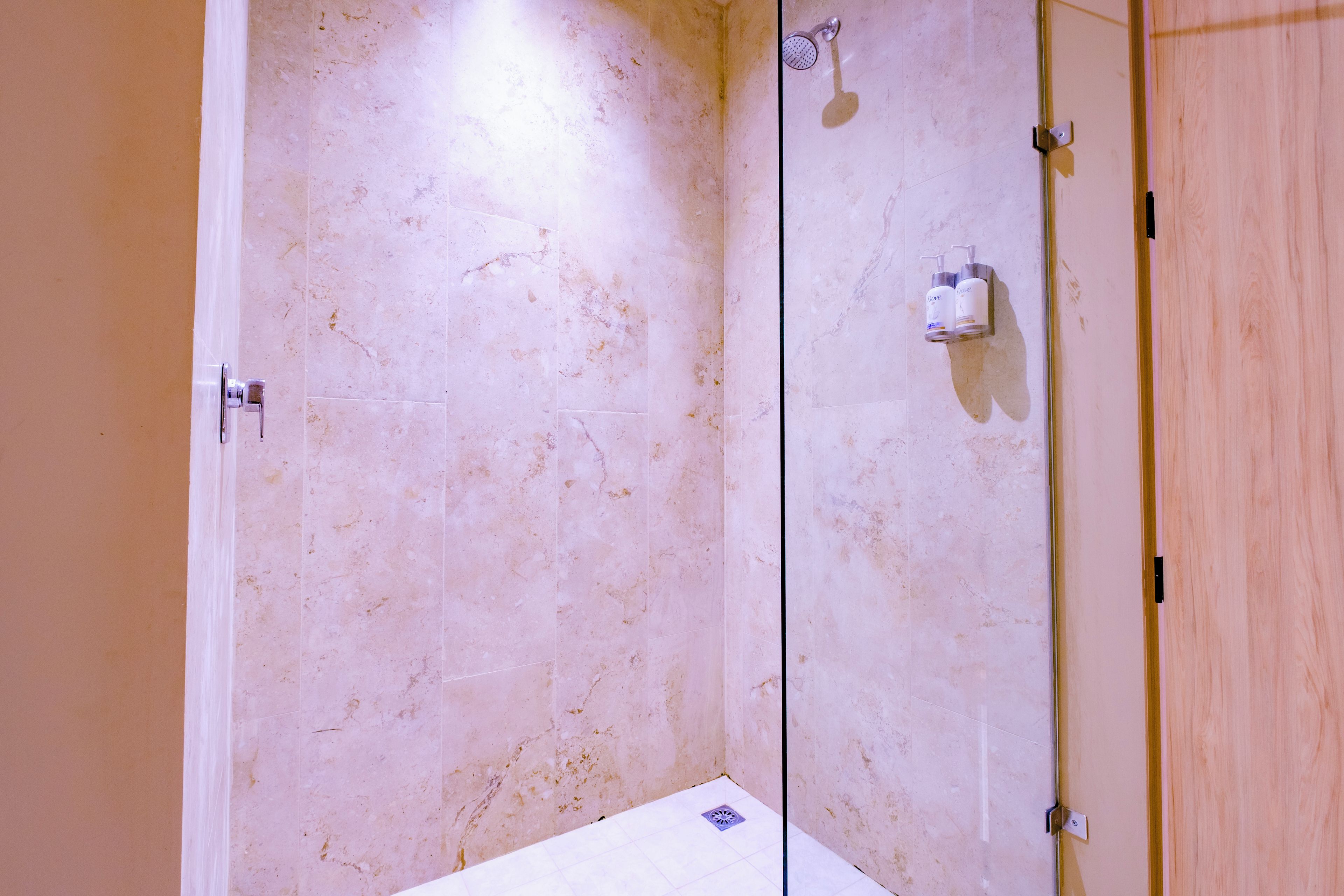 A bathroom with a shower, a toilet, and a sink.