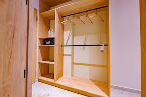 A wooden wardrobe with multiple shelves and a hanging rod.