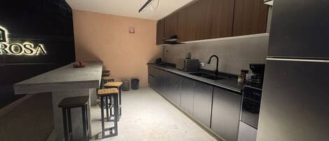 Full-size fridge, microwave, stovetop, cookware/dishes/utensils