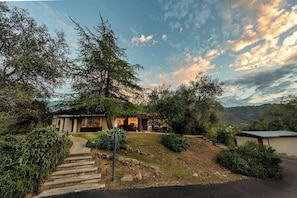 A modern building with a stone pathway leading to the entrance, surrounded by trees and a clear sky. - Sequoia Magic Views - 3BD + Hot Tub + Fireplace (Three Rivers)
