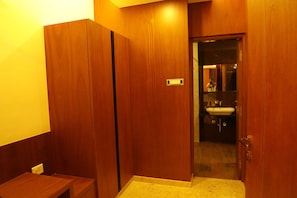 A wooden bathroom with a sink and mirror. - Hotel Maaris (Pudukkottai)