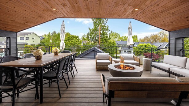 An outdoor deck with a wooden ceiling, a fire pit, and outdoor furniture. - VIEW from 2 Rooftop Decks, Walk to Kerry Park, Minutes to DT and Space Needle (Seattle)