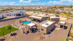 Un barrio residencial con casas modernas, una piscina y cielo despejado.