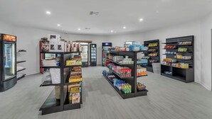 En ren och väl upplyst butik med hyllor fyllda med olika produkter, inklusive snacks och drycker.
