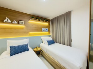 A hotel room with two beds, a wooden headboard, a shelf with decorative items, and a large window with curtains. - Falésia Seixas – Charme à Beira-Mar (João Pessoa)