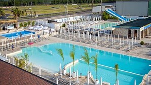 A resort with multiple swimming pools, lounge areas, and a mountainous backdrop. - Hotel Saturday (Palma Campania)
