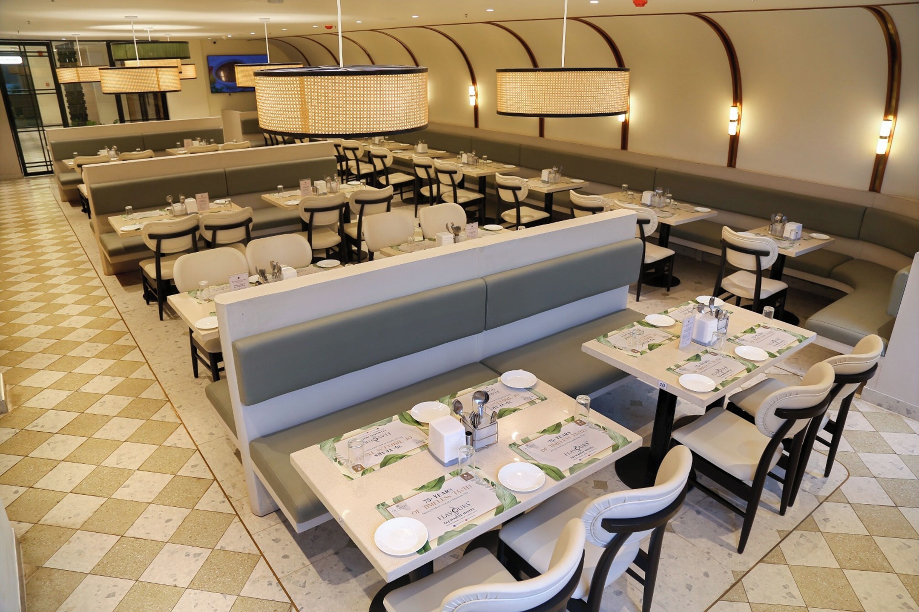 A restaurant with booths and tables, check-in counters, and a check-in desk.