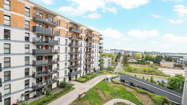 A multi-story residential building with balconies, a central courtyard, and a view of the surrounding area. - Warszawa Rakowska Homely Apartment (Warszawa)