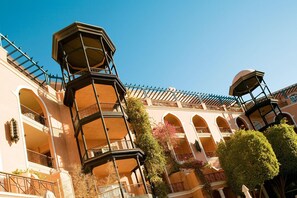 A multi-story building with balconies, arched windows, and a central tower. - Grand Resort (Hurghada)