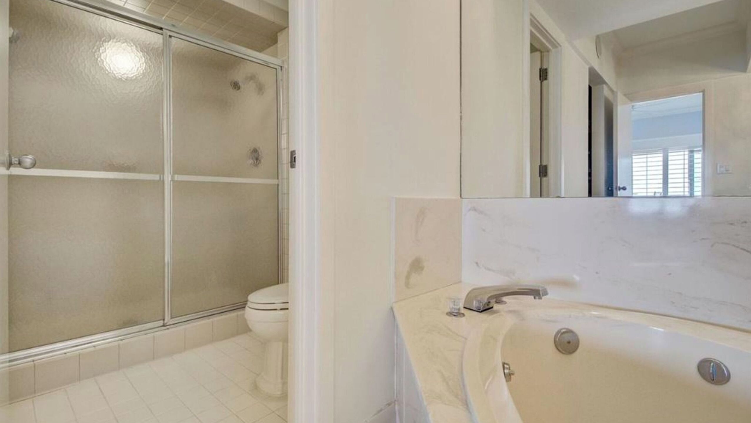 Une salle de bain avec douche, toilettes et baignoire.