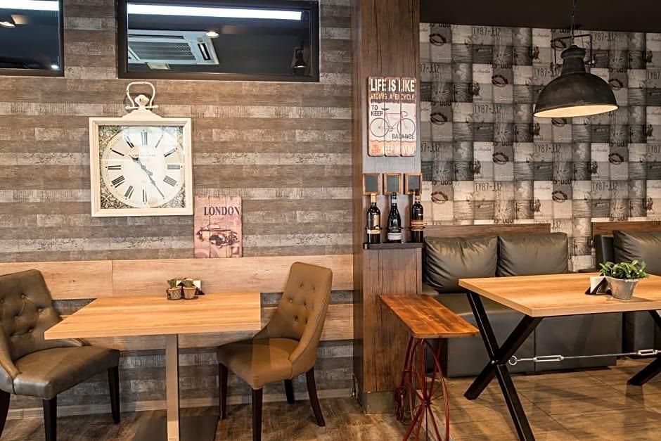A modern interior with wooden walls, a clock, a bicycle-themed sign, and leather seating.