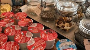 A table with yogurt containers, jars of nuts, and milk cartons. - Villagio La Darsena (Scarlino)