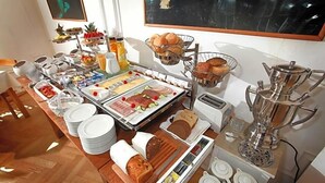 A buffet with various food items, a coffee station, and a tea station. - Fresena (Hamburg)