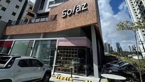 A modern building with a prominent 'Solaz' sign, indicating a hotel or apartment complex. - Bela Hospedagem - 105 Solaz Smart (João Pessoa)