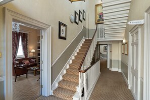 A grand staircase with a patterned carpet, a reception sign, and framed pictures on the walls. - Dukes Hotel (Bath)