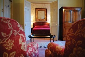 A room with a bed, a wooden cabinet, and a patterned armchair. - Dukes Hotel (Bath)