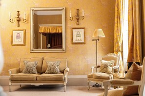 A room with a sofa, armchair, and a large mirror. - Dukes Hotel (Bath)