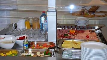 A buffet with various food items and beverages.
