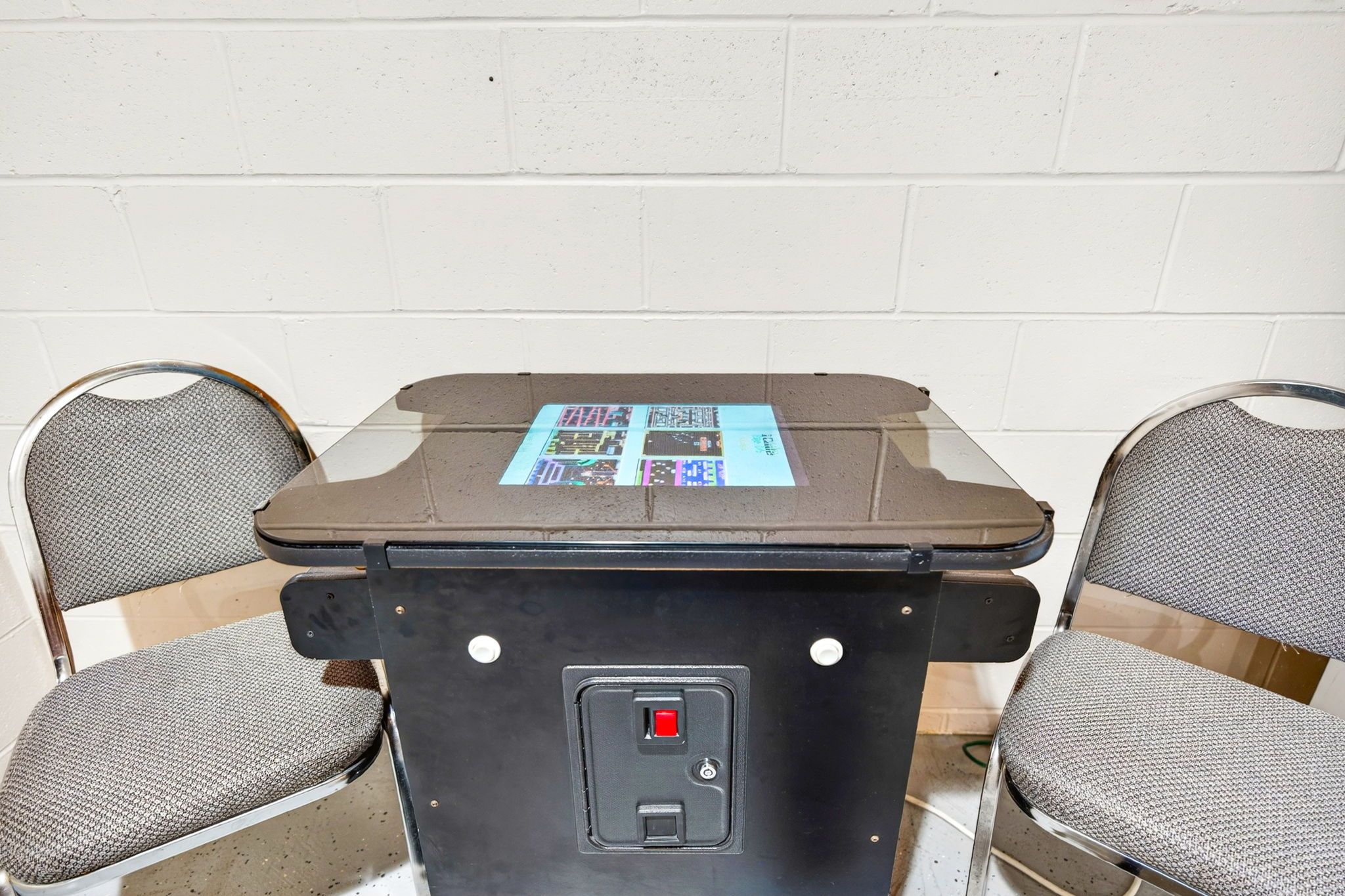 Een tafel met een tijdschrift, twee stoelen en een stopcontact.