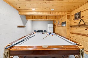 A pool table with balls and cues, a refrigerator, and a sign for 'Youngstown Black & Tan'. - Relax & Play Hot Tub, Pool Table, Yes to pets! (Logan)
