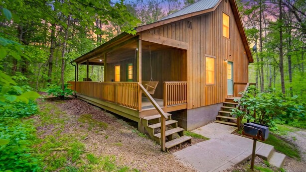 A wooden cabin with a porch, steps, and a mailbox. - Turkey Run, Cozy Woodland Cabin Retreat in the Heart of Hocking Hills, Hot Tub (Logan)