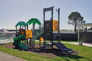 A playground with slides and climbing structures.