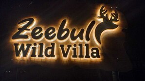 A sign for 'Zeebul Wild Villa' with a deer silhouette.