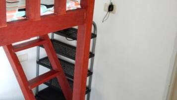 A red metal shelf unit with multiple tiers, likely used for storage or display.