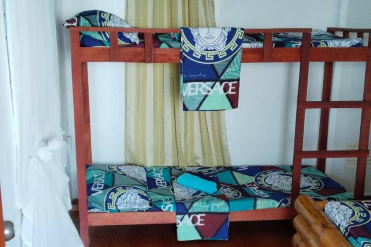 A bunk bed with patterned bedding and a wooden frame.