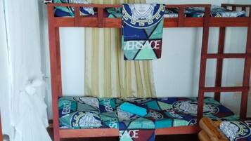 A bunk bed with patterned bedding and a wooden frame.