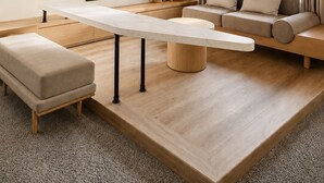 A modern living room with a flat-screen TV, a long dining table, a sofa, and a coffee table. - KIORI Collection Gokomachi (Kyoto)